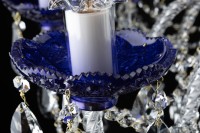 Detail of a precisely cut violet crystal glass light bowl (bobeches)