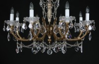 Detail of the lower part of the chandelier with 8 arms made of vacuum-cast brass