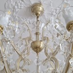 Detail of the cut upper vase of the chandelier and the ceiling glass cover