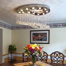 Modern chandeliers with a metal mirror in the shape of a painting palette decorated with colored crystal balls