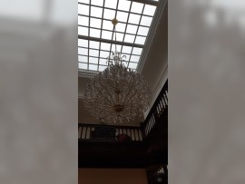 Dark interior of a villa with an extinguished chandelier