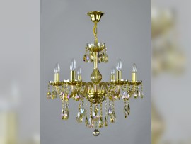 6-arm chandelier made of plated crystal in an amber shade on a light background