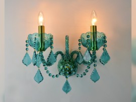 Blue-green wall light with golden brass tubes (when lit)