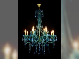 Decorative blue-green crystal chandelier with golden brass tubes (when lit)