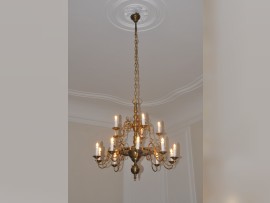 General view of a replica of a lit antique chandelier