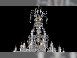 The upper part of a luxury chandelier with crutches made of glass