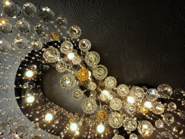 A view of the mirror of a chandelier with suspended balls