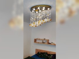 8-bulb version of the chandelier above the bed in the bedroom