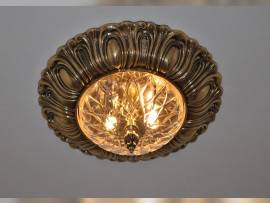 Lit-on gold surface mounted chandelier with cut glass