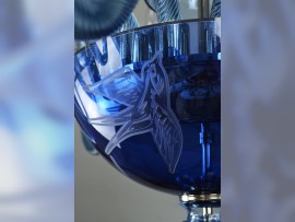 The lower bowl of the chandelier decorated with an etched swallow