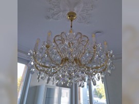 12-arm chandelier in a white kitchen