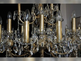 Detail of a large 28-bulb golden chandelier - cover tubes