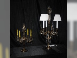 Candlestick and tall lamp next to each other