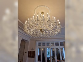 A luxurious crystal chandelier with a diameter of 165 cm decorated with a rosette