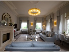 A golden ring chandelier made of clear crystal hung in the interior of the living room