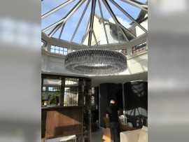 A large ring chandelier in the interior of the conservatory - dia 100 x 20 cm, shiny silver, smoky crystal