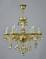 6-arm chandelier made of plated crystal in an amber shade on a light background