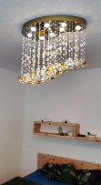 8-bulb version of the chandelier above the bed in the bedroom